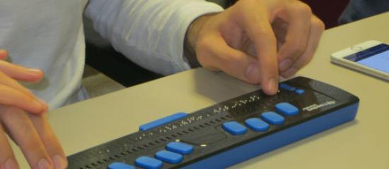 A person using a Braille display